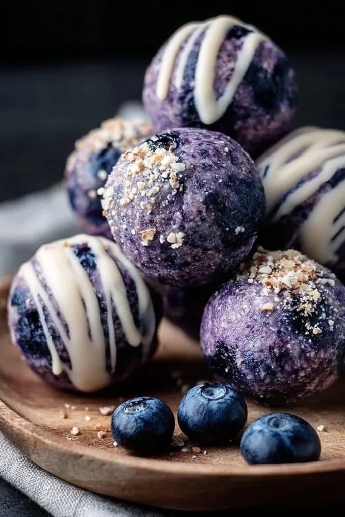 Homemade blueberry cheesecake protein bites on a white plate