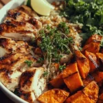 Delicious grilled chicken served over a bed of sweet potatoes in a vibrant bowl.