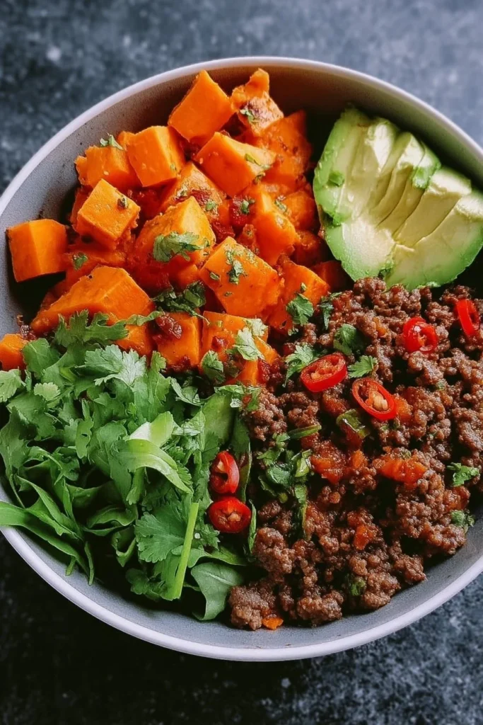 Spicy Ground Beef Sweet Potato Protein Bowl filled with nutritious ingredients.