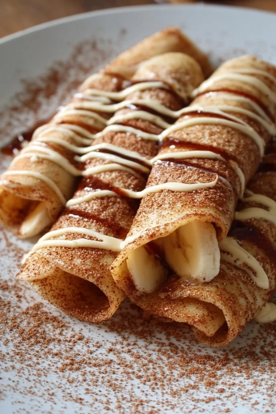 Cinnamon Roll Protein Crepes topped with creamy icing and cinnamon