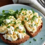 Cottage cheese egg salad made without mayo, garnished with fresh herbs.