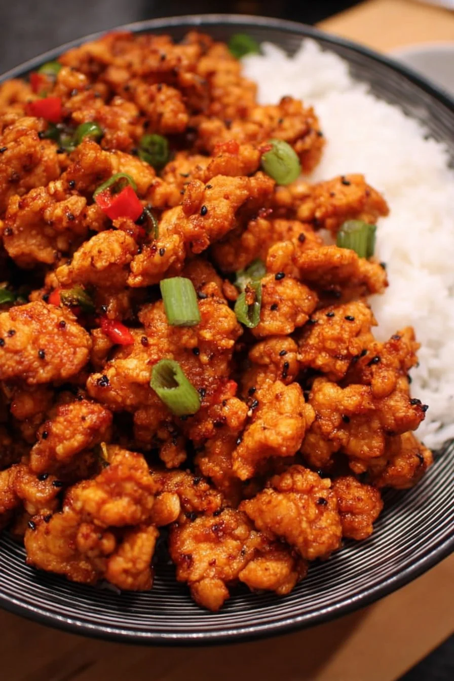 Firecracker Ground Chicken served in a bowl with fresh herbs and spices