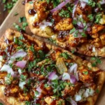 BBQ chicken flatbreads topped with fresh ingredients and drizzled with sauce