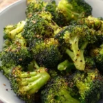 Crispy air fryer broccoli served in a bowl, garnished with herbs