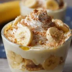 Protein-packed banana pudding served in a bowl with fresh banana slices.