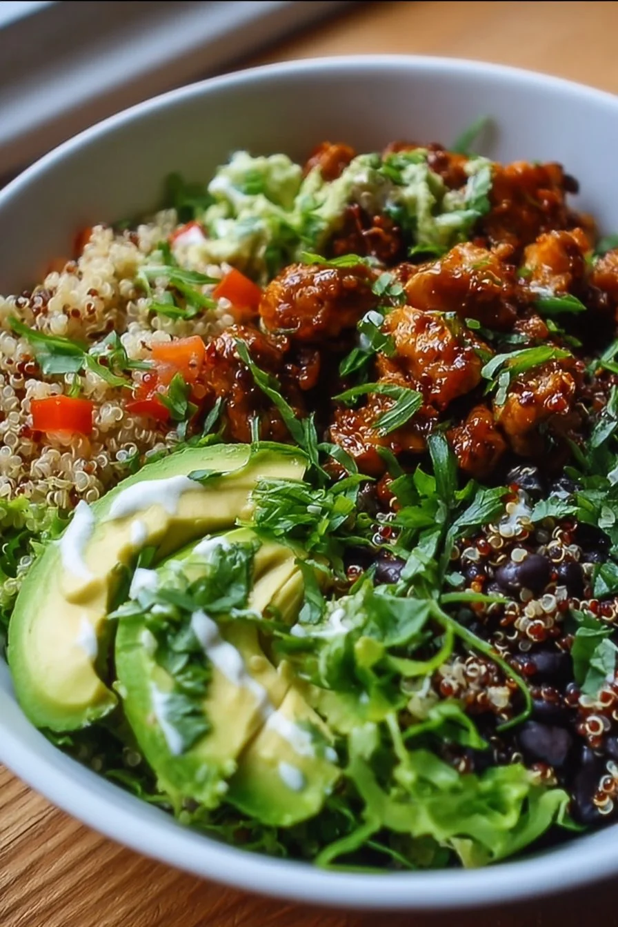 Savory chicken quinoa bowl with vegetables and herbs.