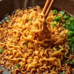 Bowl of savory saucy ramen noodles with vibrant toppings