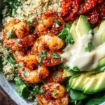 Shrimp quinoa bowl with vibrant vegetables and seasoning